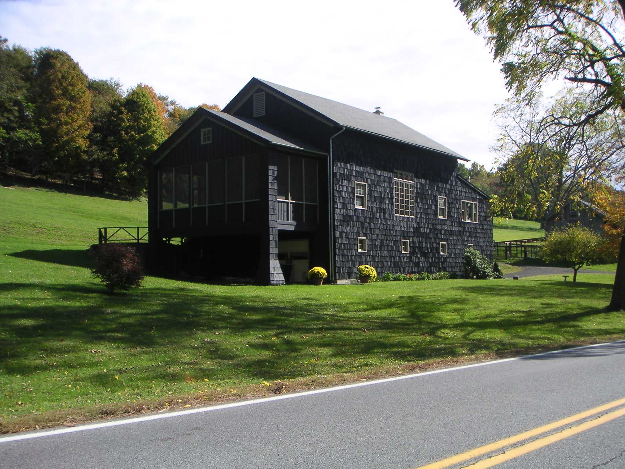 Exterior shot of a dark wood country barn